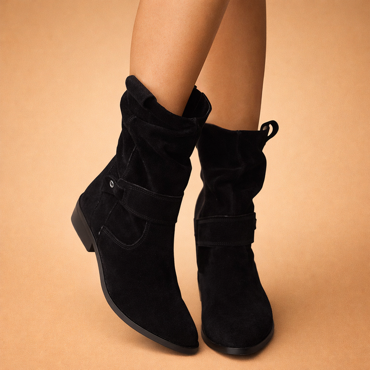 Stylish women's slouchy ankle boots with decorative buckles. Elegant and comfortable winter footwear for women.