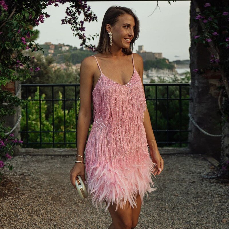Back view of the women's trendy mini dress with delicate spaghetti straps and a feathery, fitted silhouette.