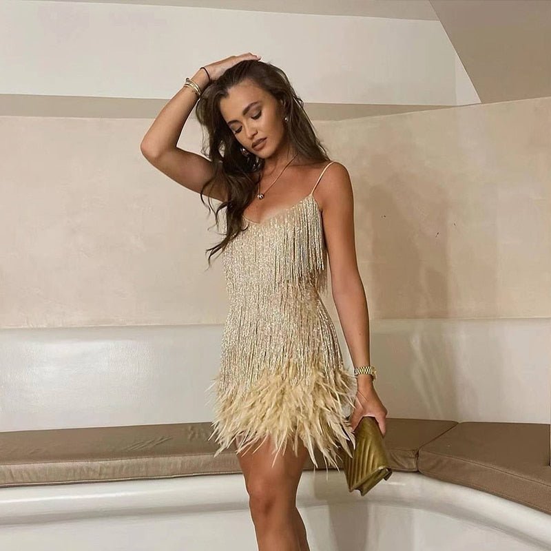 Close-up of the women's spaghetti strap mini dress showing detailed feather accents and fitted design.