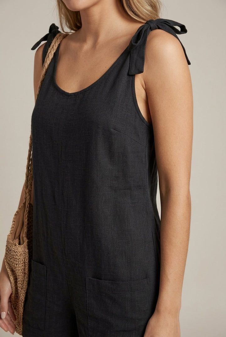 Stylish women's bow strap playsuit, ideal for summer vacation and relaxed casual outfits.
