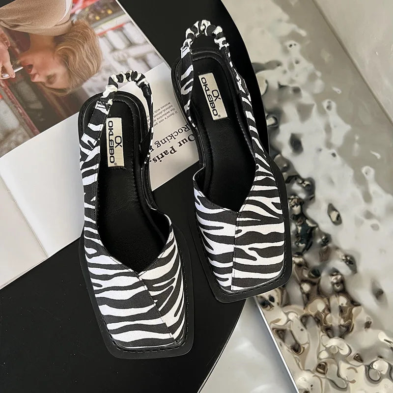 Pair of women's elegant slingback sandals with a sleek square toe, versatile footwear