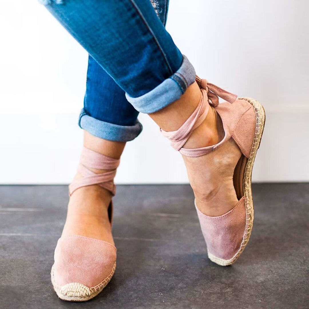 Fashionable women's casual espadrille sandals with adjustable tie straps for summer wear.