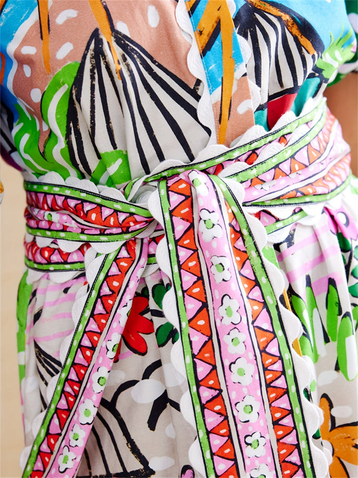 Vacation-ready women's chic tropical midi dress. Elegant summer style with lapel neckline. Versatile design.