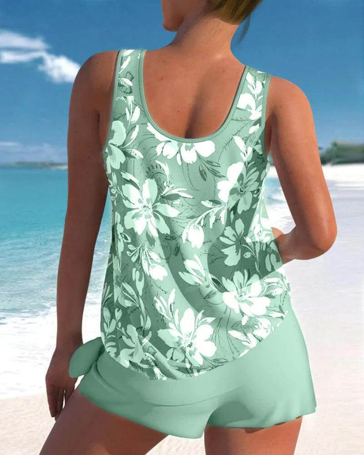 Model wearing a comfortable & chic women's two-piece tankini swimsuit. Perfect summer bathing suit.