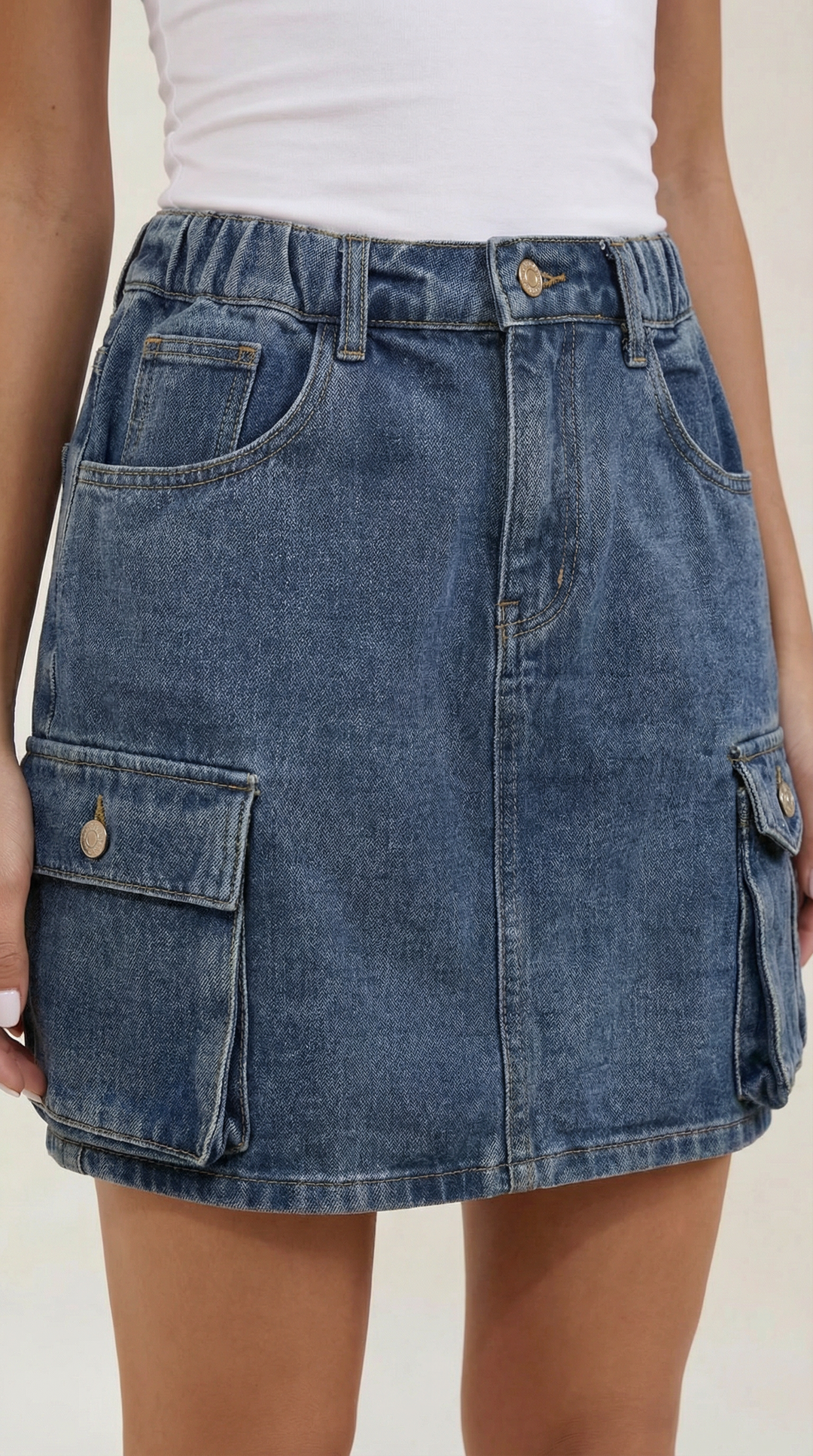 Detail of women's utility cargo mini skirt showing functional pockets and A-line cut, perfect for trendsetters.