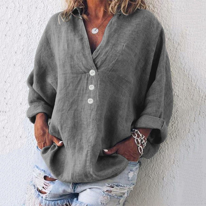 Chic women's V-neck long sleeve blouse, relaxed oversized fit, featuring practical roll-tab sleeves.