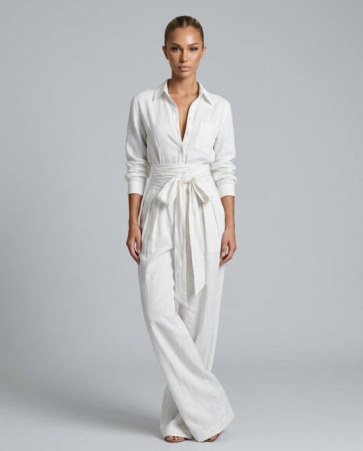 Model wearing a chic women's wide leg jumpsuit with button front, styled for a relaxed elegant look.