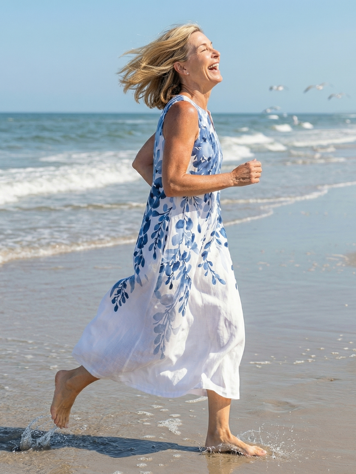 Relaxed fit women's sleeveless maxi dress, white with botanical print. Comfortable casual wear, vacation, or summer outfit.