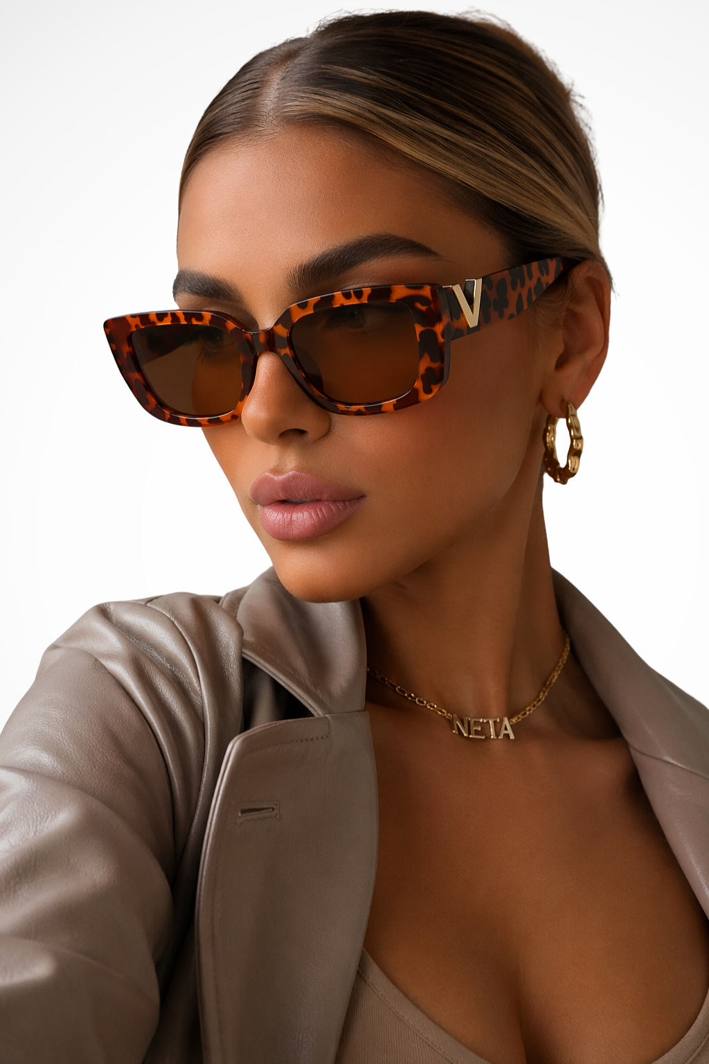 Chunky cat eye sunglasses for women with a prominent gold V detail, a modern and stylish eyewear accessory.