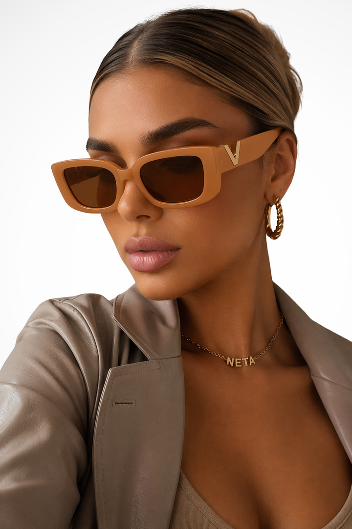Fashionable women's chunky cat eye sunglasses with unique gold V accents, adding a chic touch to any outfit.