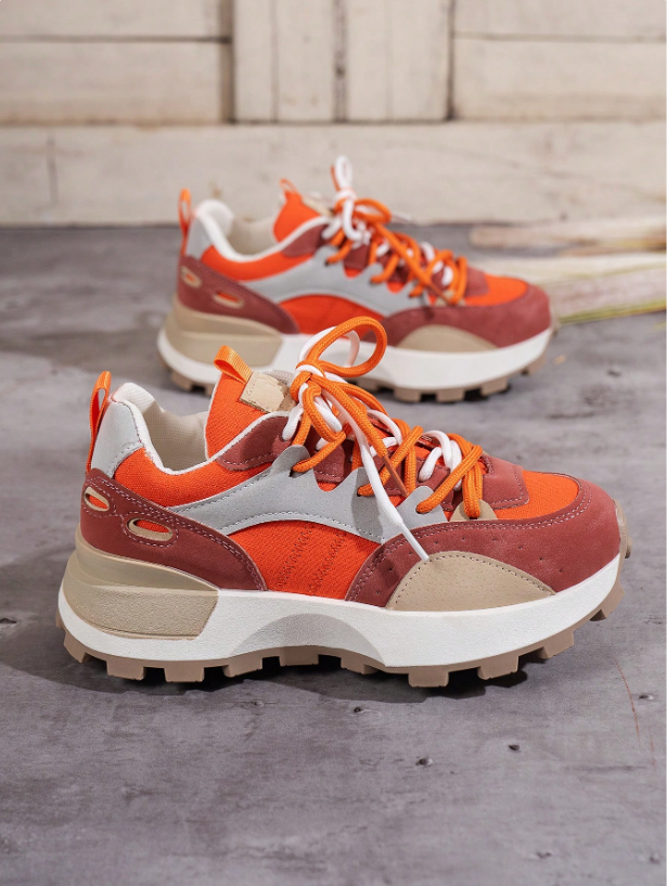 Trendy women's chunky platform sneakers with a bold colourblock pattern, offering style and comfort.