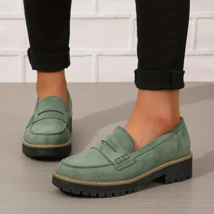 Women's footwear: chunky sole loafers with vamp strap. Comfortable and stylish flats for casual occasions.