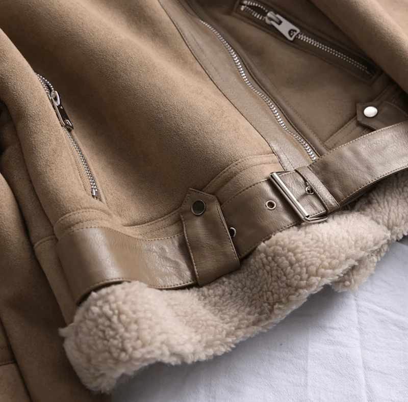Detailed shot of a women's chic aviator jacket, featuring quality zippers, pockets, and a warm, durable design.