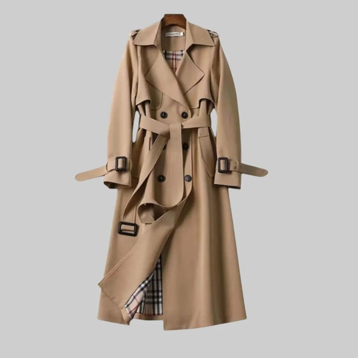 Women's classic beige double-breasted trench coat with belt, perfect for elegant autumn & spring outerwear.