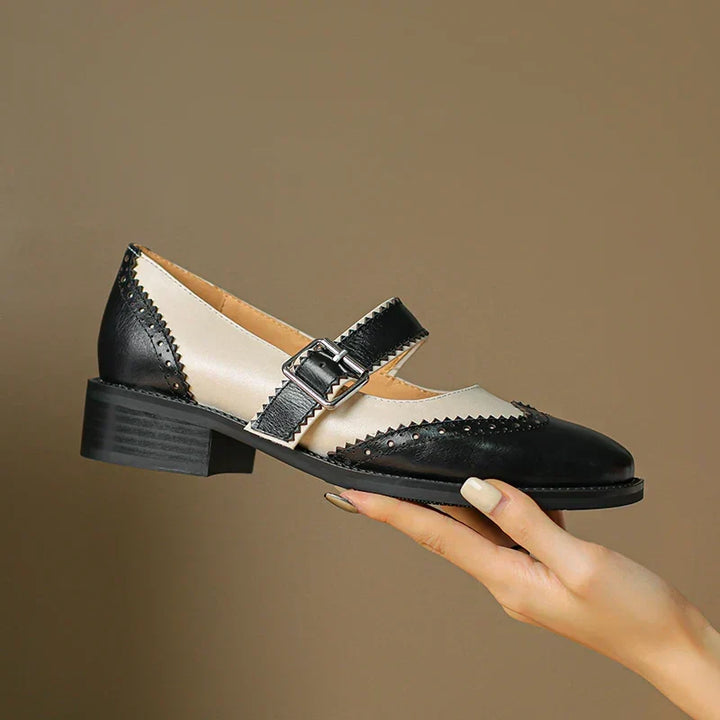 Elegant women's black leather Mary Janes with a stylish buckle strap, ideal for comfortable everyday wear.