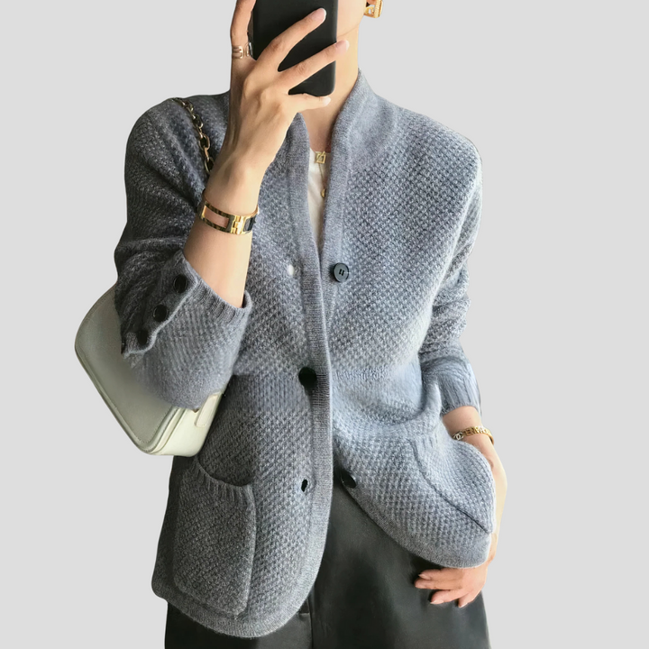 Model wearing a versatile women's cashmere v-neck cardigan, perfect for layering in classic style.