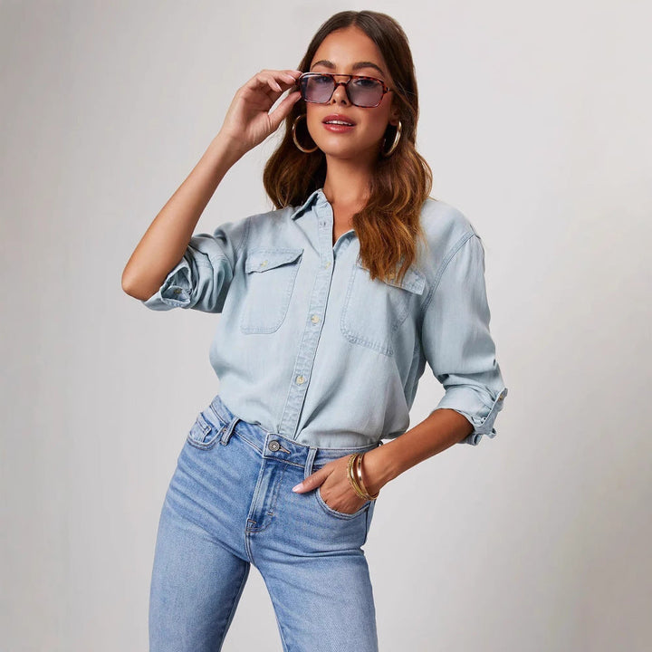 Stylish women's classic denim shirt. Button-down, long sleeve top for a chic, casual look.