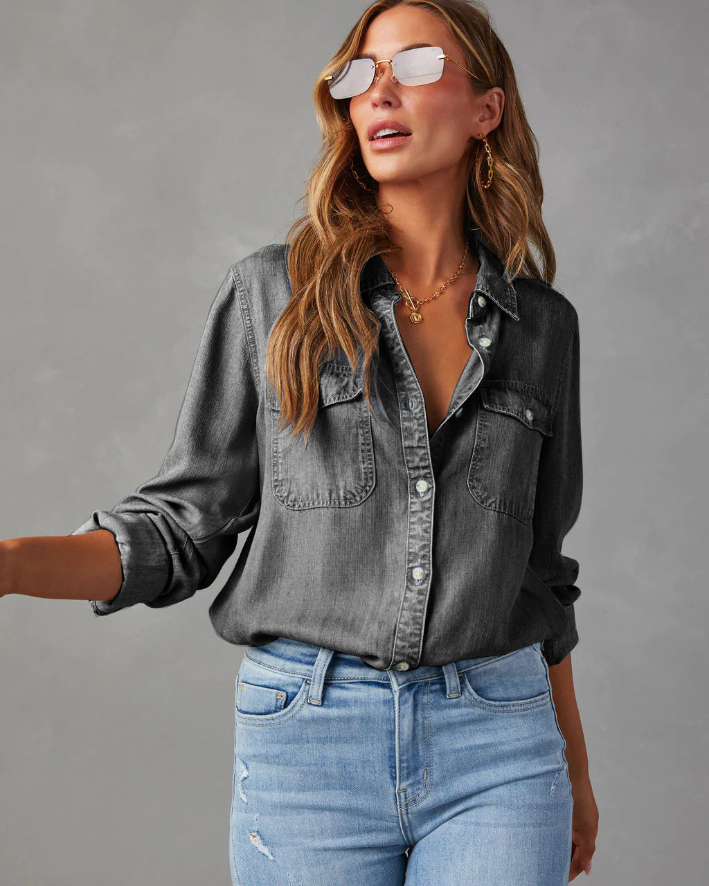 Classic blue denim long sleeve women's shirt. Button-down design for versatile casual style.