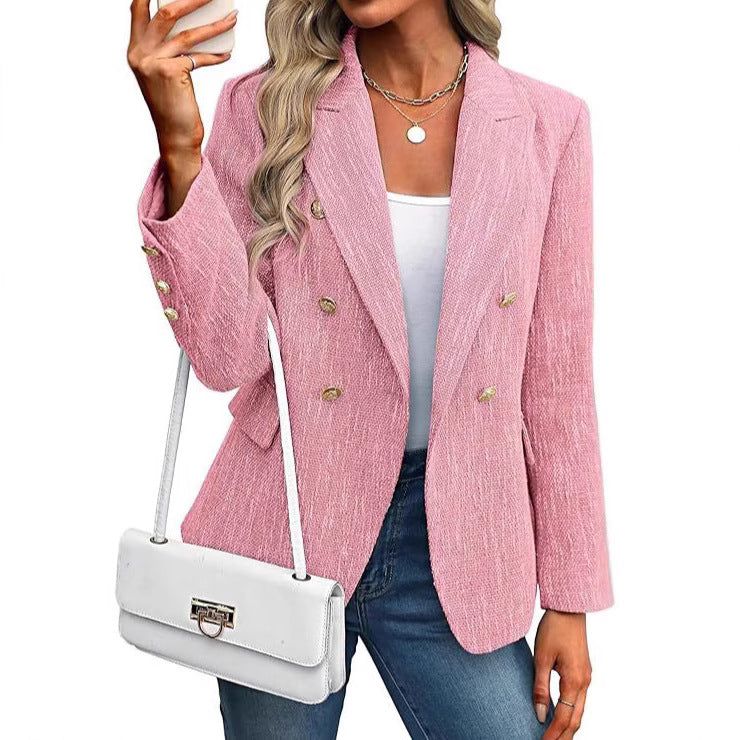 Fashionable women's double-breasted blazer with ornate buttons, perfect for sophisticated outerwear.