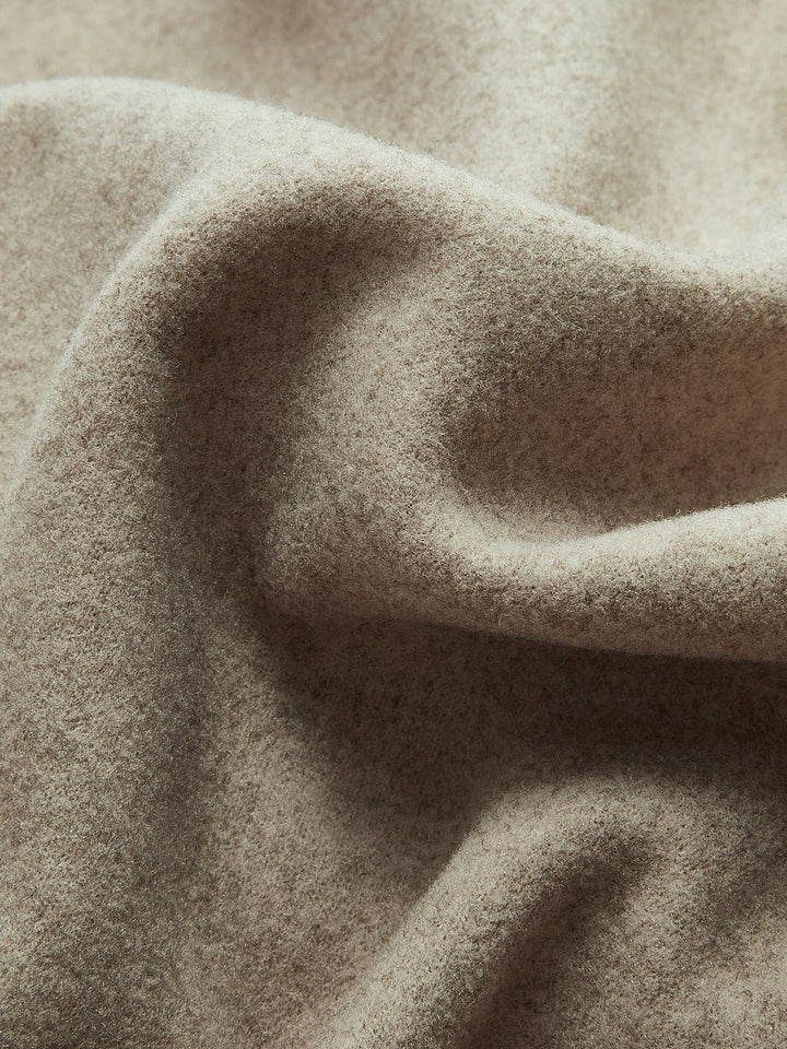 Double-breasted women's pea coat, featuring a button front closure for classic warmth and style.