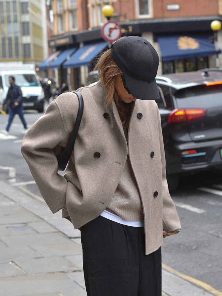 Stylish women's double breasted pea coat with stand collar & button front, perfect winter outerwear.
