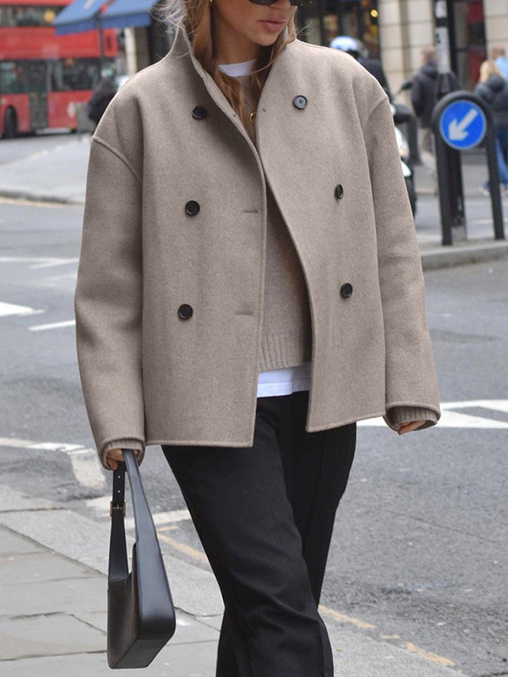 Classic women's pea coat, double breasted, offering timeless style & warmth for cold weather.