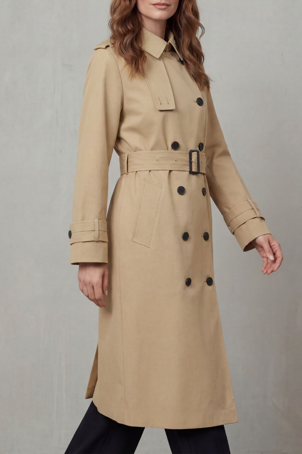 Back view of women's classic trench coat showing storm flap & single vent. Stylish, timeless fall outerwear.