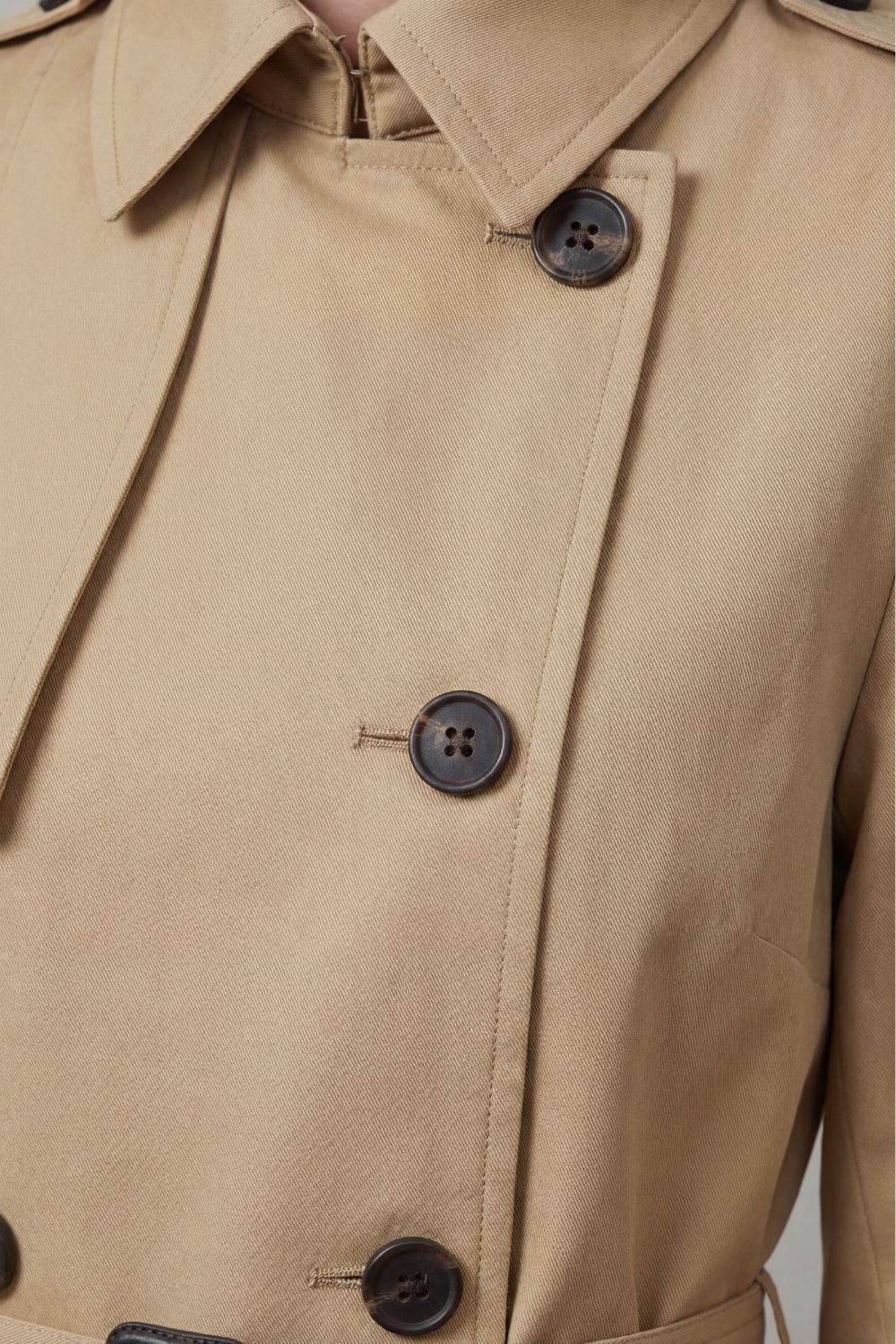 Women's classic beige double-breasted trench coat, a versatile and elegant piece for any wardrobe.