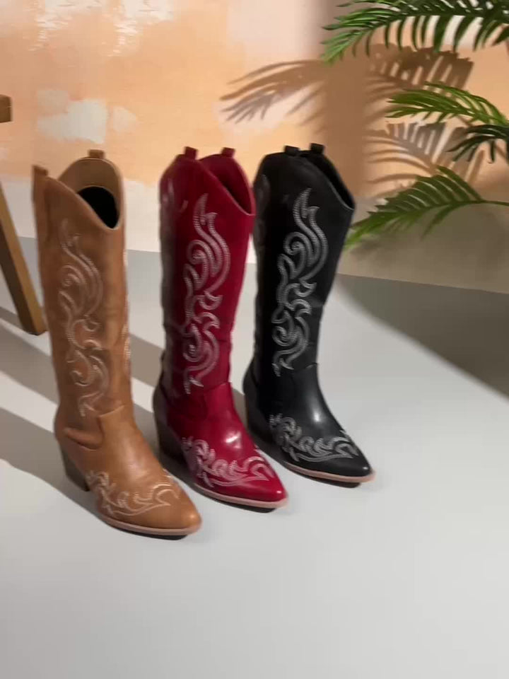 Classic women's knee-high cowboy boots, featuring a block heel, pointed toe, & timeless western design.