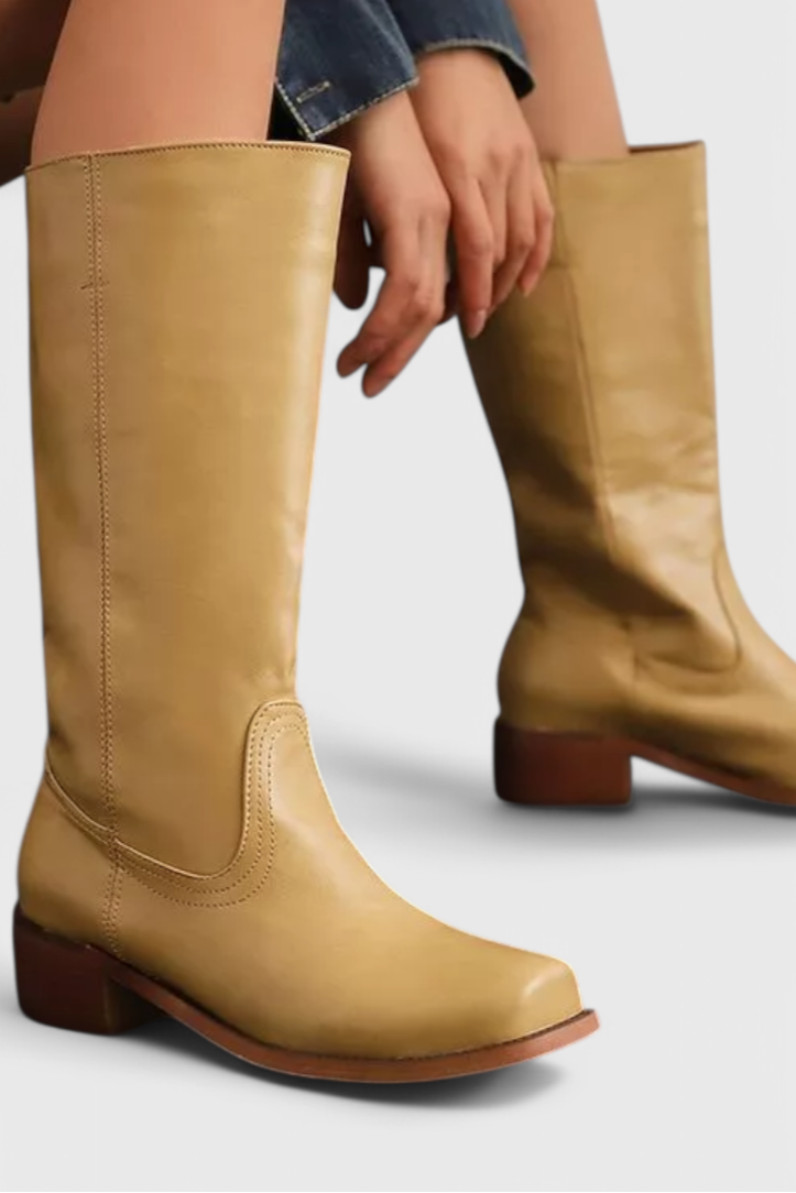Women's classic knee-high heeled boots for elegant winter style. Versatile fashion footwear.