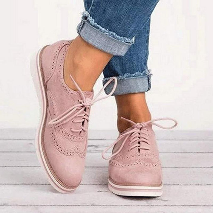 Women's classic lace-up brogue trainers with a comfortable flat sole, perfect for versatile everyday style.