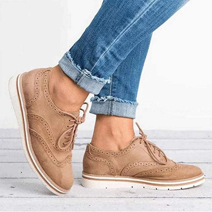 Stylish women's lace-up brogue trainers, ideal for office wear or casual fashion, featuring intricate perforations.