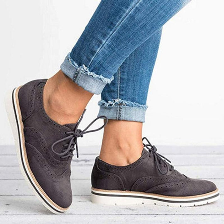 Versatile women's footwear: lace-up brogue trainers offering classic style & all-day comfort for various outfits.