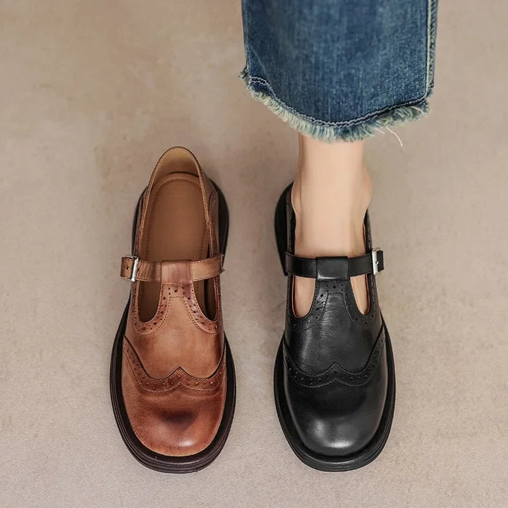 Stylish women's Mary-Jane flat sandals with a comfortable design, buckle closure and intricate brogue pattern.