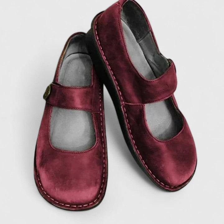 Brown women's classic Mary Jane comfort shoes, flat with strap, rounded toe, and durable stitch-defined sole.
