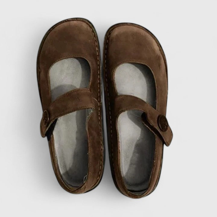 Classic women's Mary Jane flat shoes with a comfortable strap, rounded toe, and distinct stitch-defined sole.