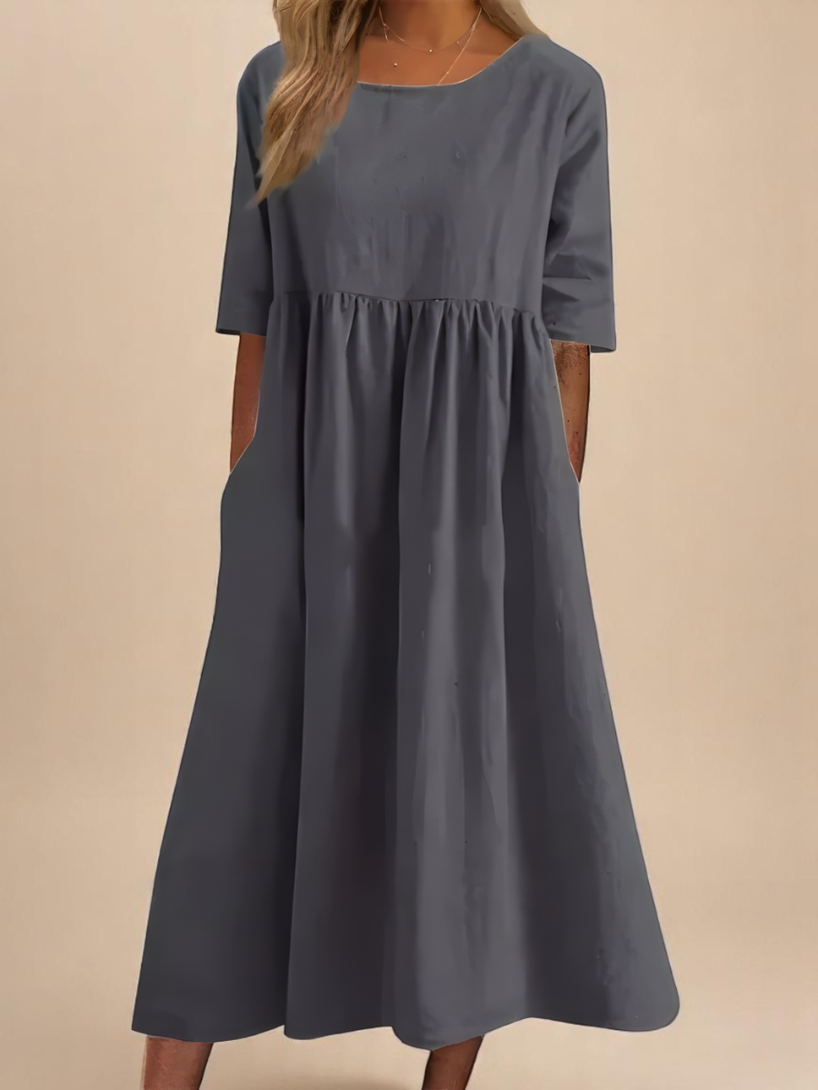 Blue women's casual dress with mid sleeves, round neck, & pockets. Perfect for summer style.