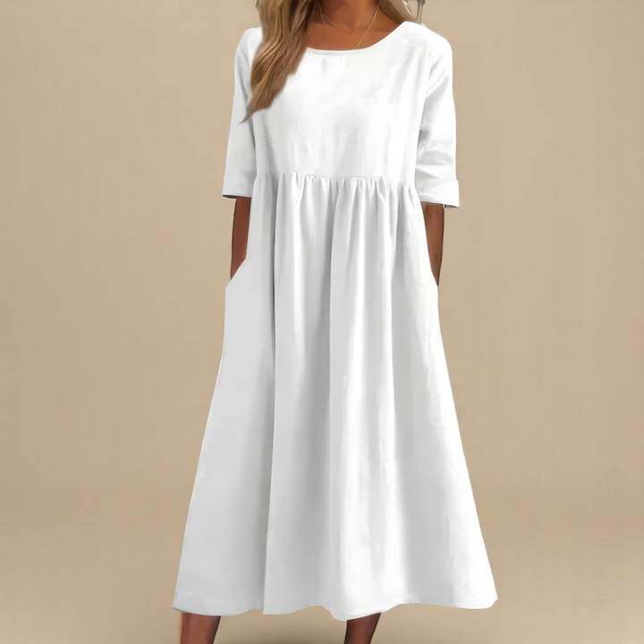Casual women's midi dress featuring mid sleeves, round neck, & practical pockets for daily wear.