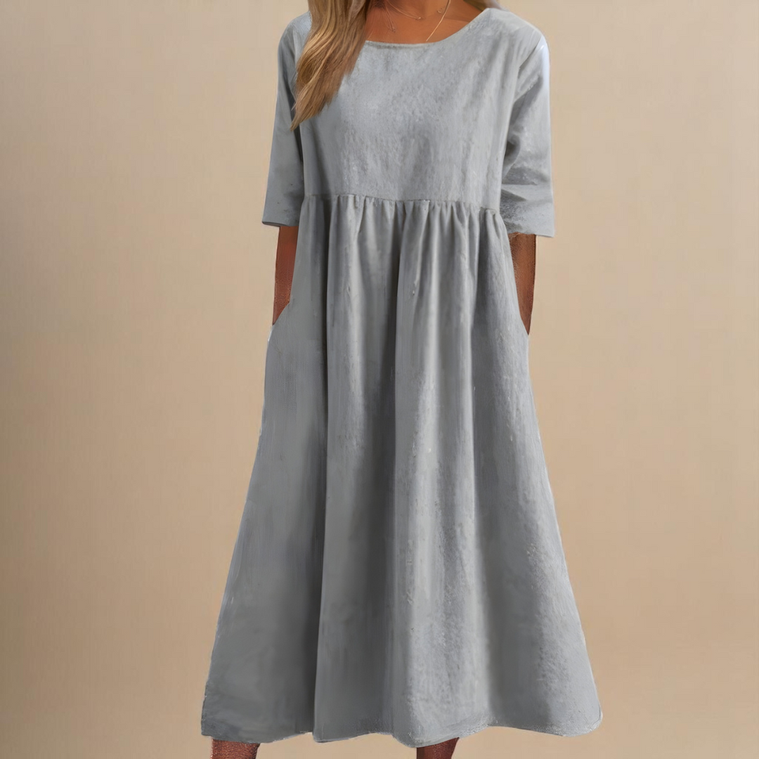 Classic women's mid-sleeve midi dress with round neck, relaxed fit, and practical pockets.