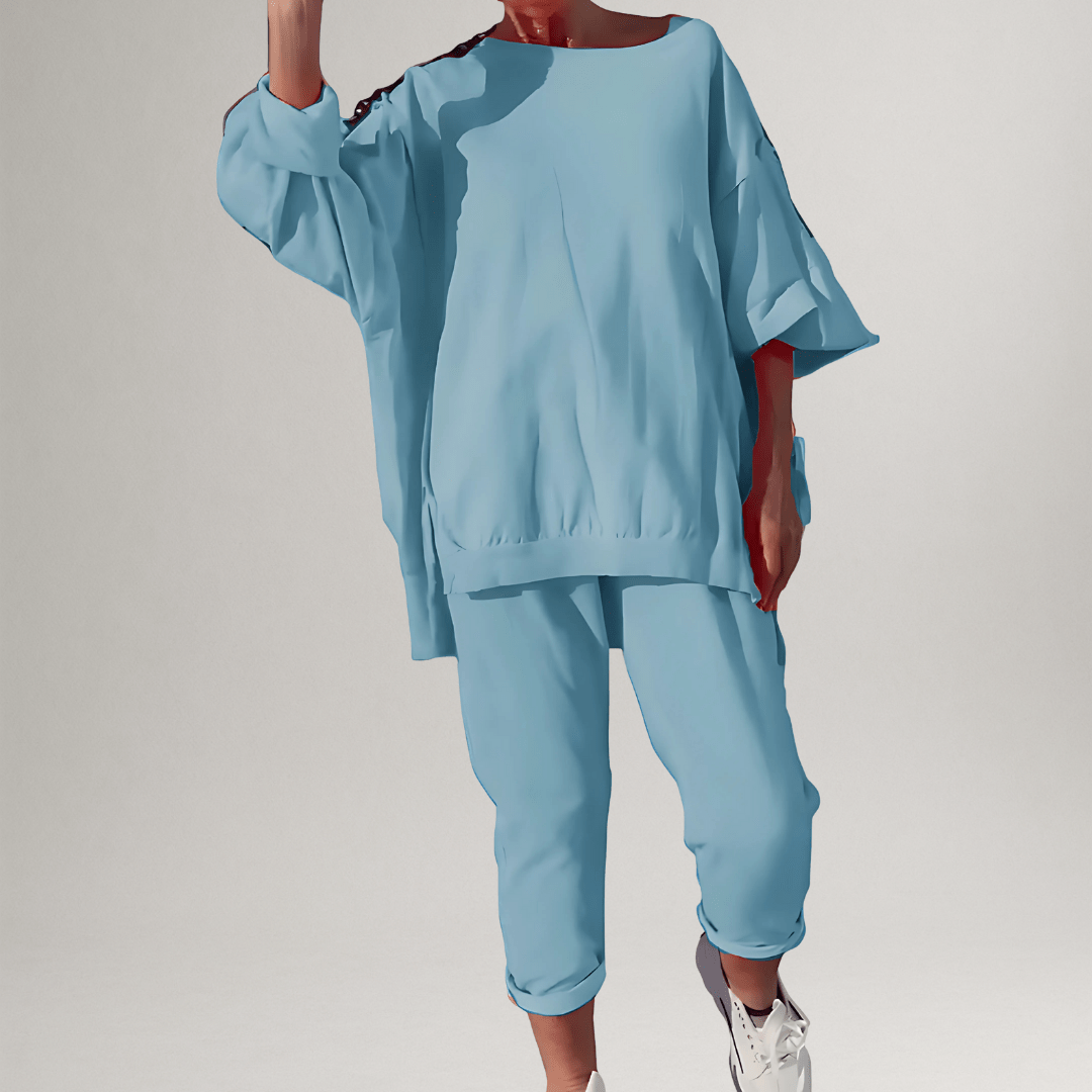 Stylish women's oversized two-piece lounge set, perfect for casual wear, includes a comfy blouse & trousers.