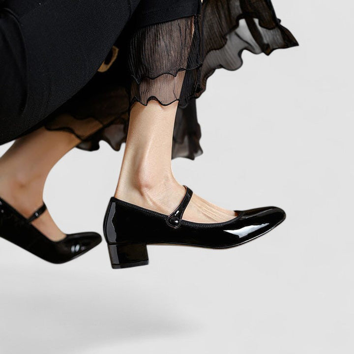 Elegant women's patent Mary Jane heels. Classic block heel, buckled strap, perfect for work or formal events.
