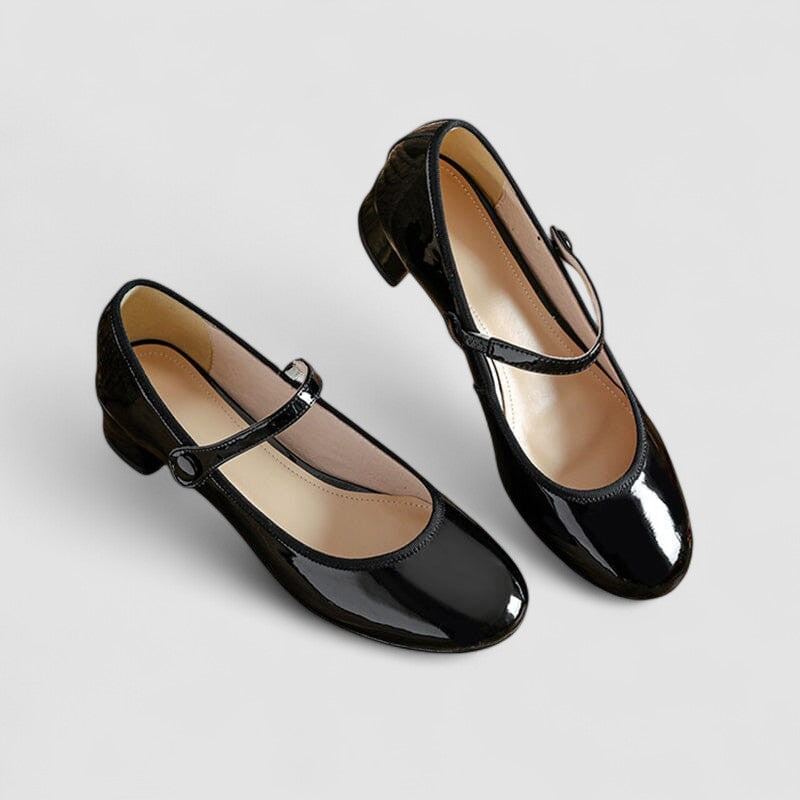 Classic patent Mary Jane heels for women with a sturdy block heel, rounded toe, and adjustable strap.