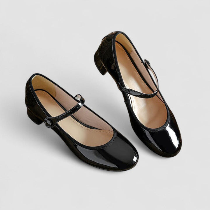 Classic patent Mary Jane heels for women with a sturdy block heel, rounded toe, and adjustable strap.