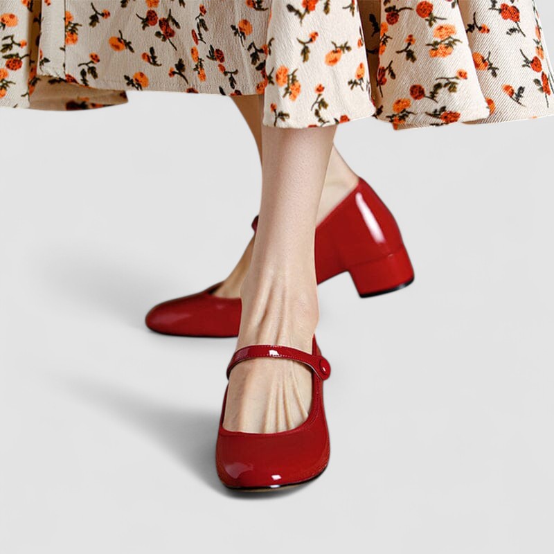 Women's elegant patent Mary Jane heels featuring a comfortable block heel, rounded toe & buckled strap.