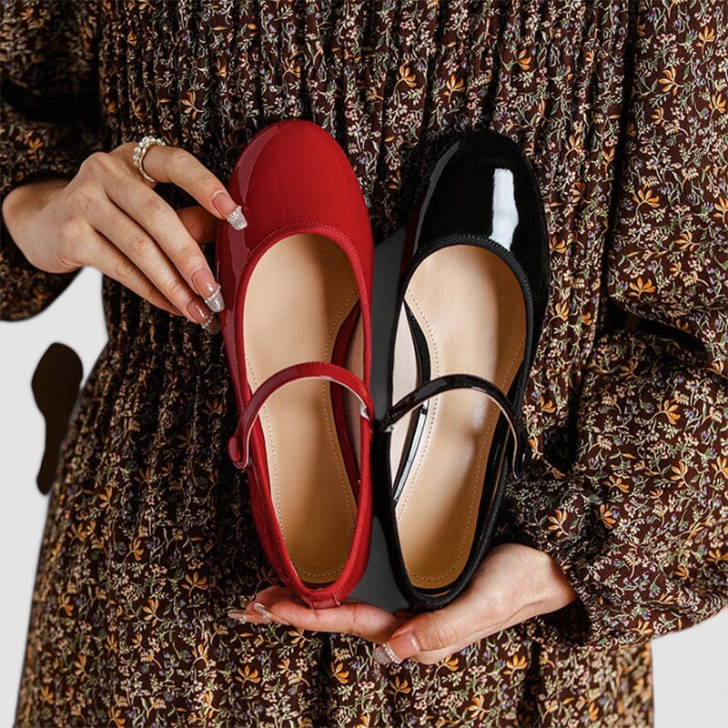 Professional women's patent Mary Jane heels. Classic block heel, rounded toe, and buckled strap for work.