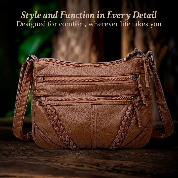 Vintage-inspired women's leather crossbody bag with practical compartments for organized everyday carry.