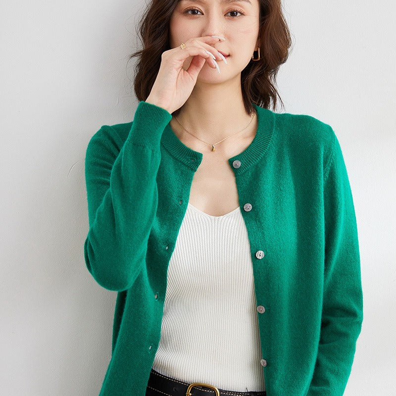 Cozy women's cardigan sweater featuring a timeless round neckline and functional button front.