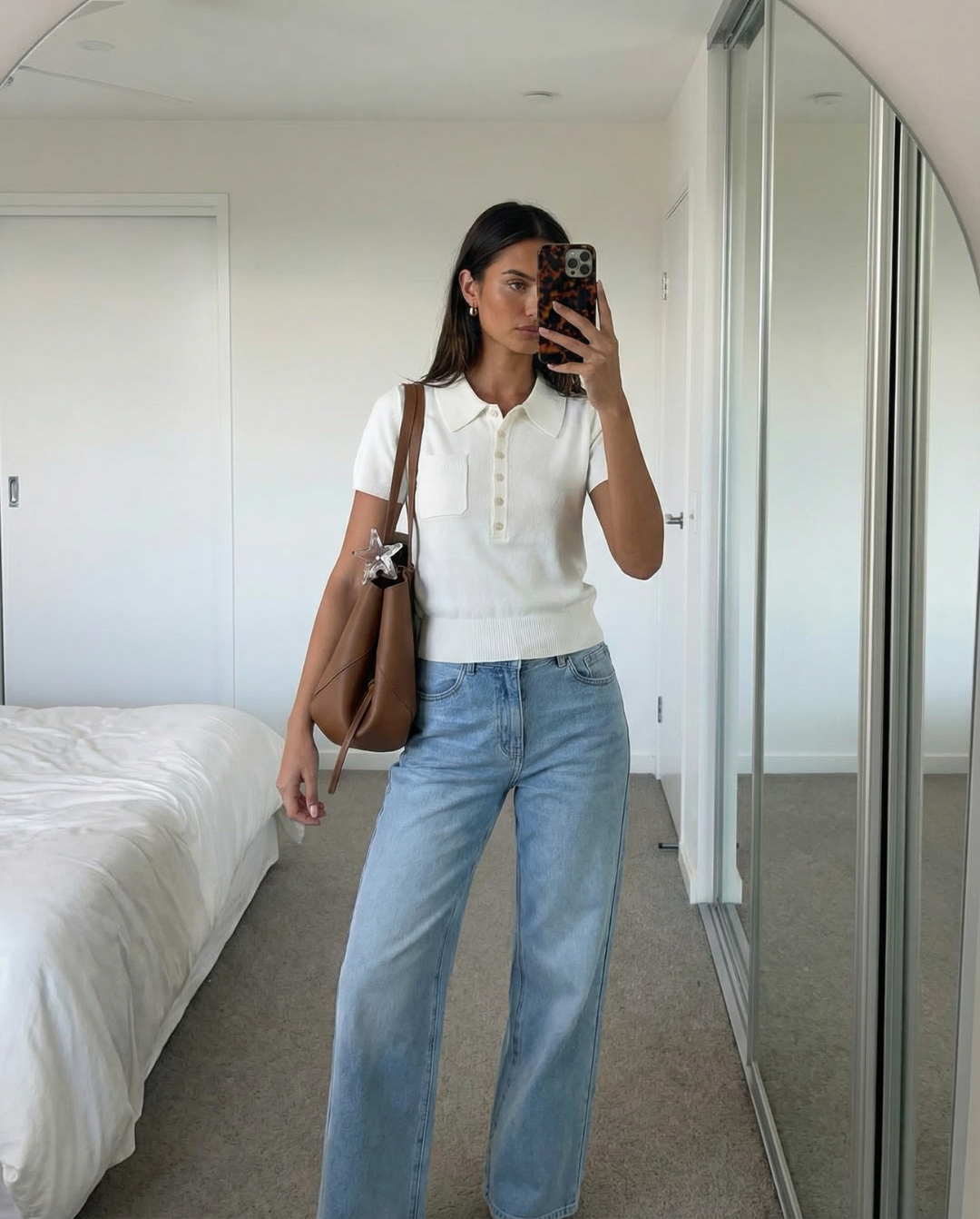 Stylish women's button polo top. Slim fit, short sleeve design for a classic, minimalist everyday look.
