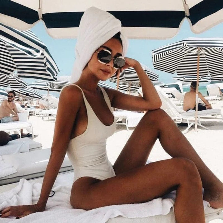 Stylish open-back one-piece swimsuit for women. Perfect classic beachwear for vacation & pool.