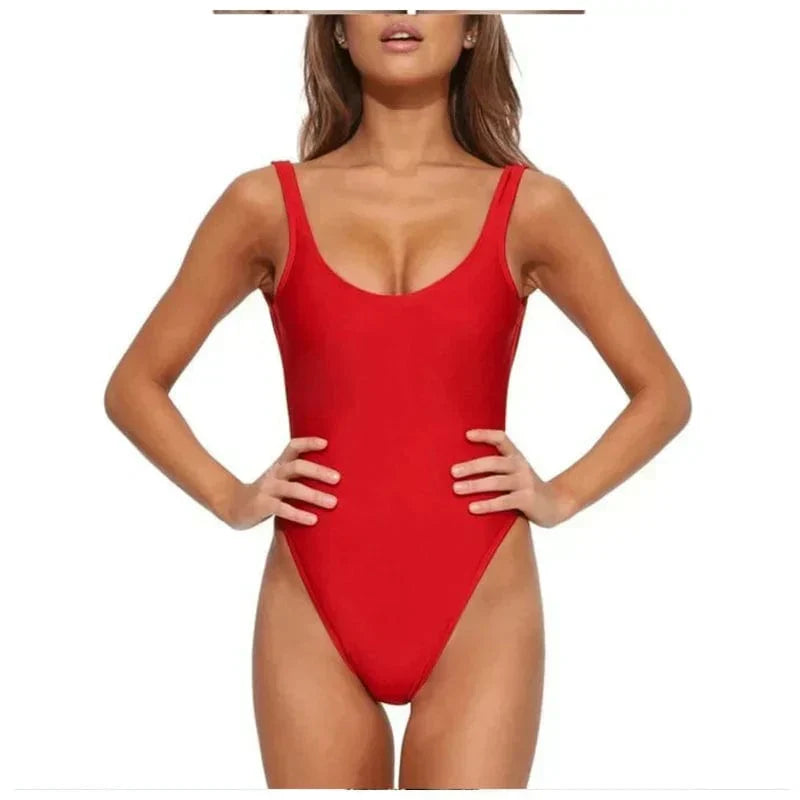 Woman wearing a fashionable open-back one-piece swimsuit, ready for a stylish day at the beach or pool.